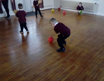 P.1 & 2 enjoying P.E in our sports hall with our Ulster Council GAA coach