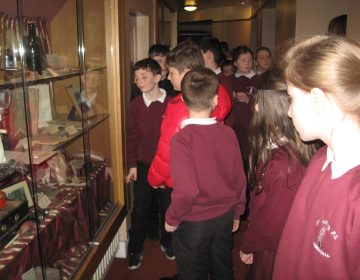 Primary 6 and 7 pupils look at antique props used in the Grand Opera House.