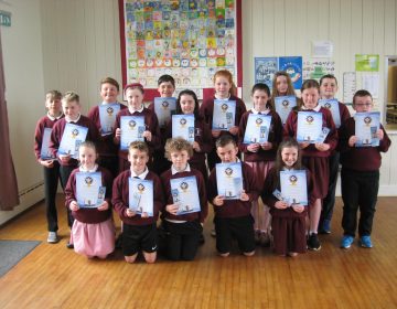 Primary 7 receive their Confirmation certificates and bookmarks.