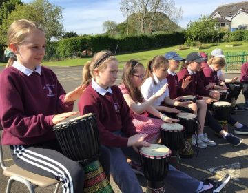 Primary Six and Seven enjoy fun with drums out in the sunshine.