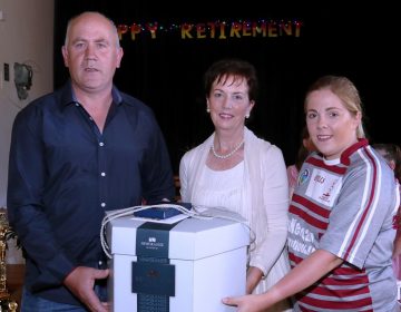 Aidan McAteer & Eimear O’Hara from Ruairí Óg Hurling & Camogie Clubs present Mrs Smart with gifts to mark her Retirement from St Mary’s Primary School.